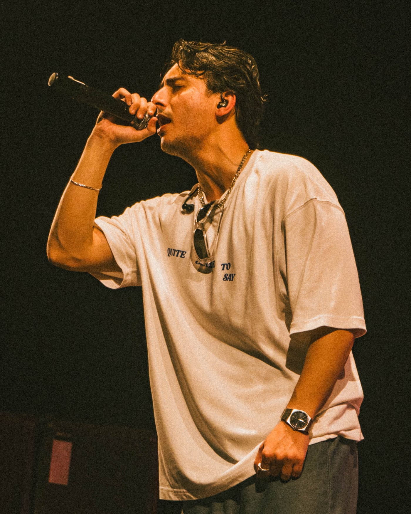 Hasan Raheem singing into the microphone on stage